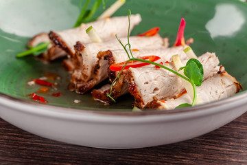 The concept of modern Japanese cuisine in 2019. Braised rabbit fillet in beer, with spicy sour-sweet sauce. beautiful serving dishes in an Asian restaurant. top view, copy space