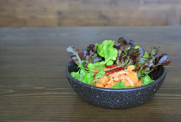 Fried spicy salmon salad mixed vegetable and herb.