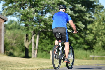 Fototapeta na wymiar Male Cyclist Working Out Wearing Helmet Riding Bike