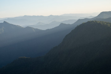 Fototapeta na wymiar Mountain layer with sun ray scenic landscape morning in bright sky.