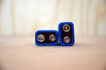 Batteries square on a wood background 3