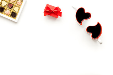 Valentine's day concept. Sweets, red gift box, heart-shaped mugs on white background top view copy space