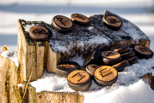 Runes carved from wood on the snow - Elder Futhark
