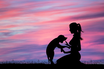 the girl with her puppy at sunset - obrazy, fototapety, plakaty