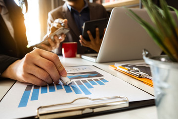 Business team meeting. professional investor working new start up project. Finance task. with smart phone and laptop and digital tablet computer  in morning light