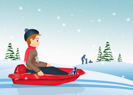 child on sleigh in winter