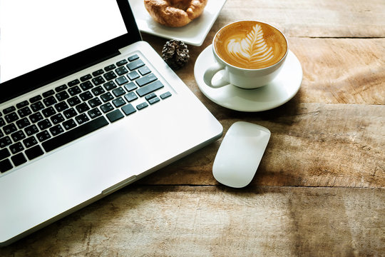 Wood office desk table with a lot of things tablet, laptop ,smartphone ,notepad and coffee cup notepad . Top view with copy space virtual interface icons screen. - Powered by Adobe