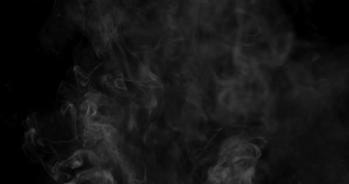 Swirling white cloud of smoke or vapor rising in slow motion against a black background