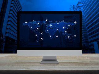 Flight routes airplanes connection and world map with modern computer monitor screen on wooden table over city tower, Airplane transportation network concept, Elements of this image furnished by NASA