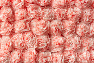 Decorative paper roses from napkins as texture background pattern. Creative festive wall decoration