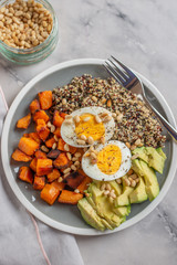 Quinoa salad in bowl with avocado