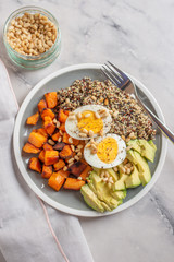 Quinoa salad in bowl with avocado