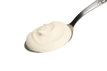 sour cream in spoon isolated on white background