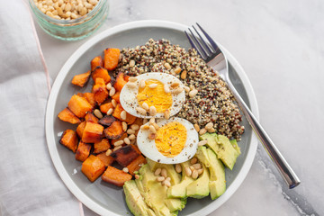Quinoa salad in bowl with avocado