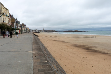 Fototapeta na wymiar Saint-Malo, France - September 12, 2018: View of beach and old town of Saint-Malo. Brittany, France