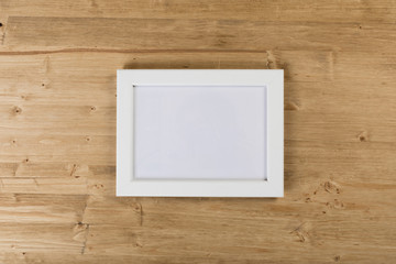 white frame on wooden background