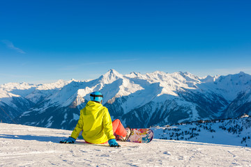 Girl snowboarder enjoys the winter ski resort.