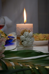 burning candle from a wedding ceremony in a restaurant. Elements of the wedding ceremony. Wedding decoration