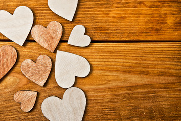 Lots of wooden hearts on the wooden table