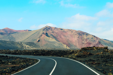 Road in Timanfaya National Park in Lanzarote,Canary Islands,Spain. The spectacular volcanic landscape background.