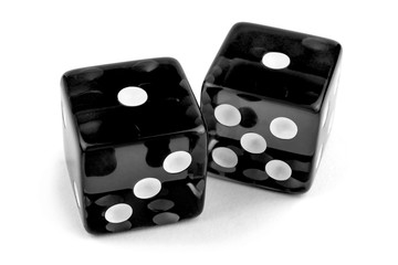 Two black glass dice isolated on white background. One and one