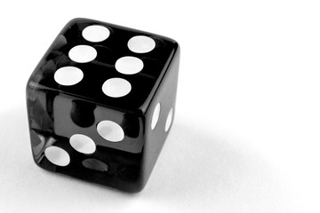 One black glass dice isolated on white background with copy space, six.