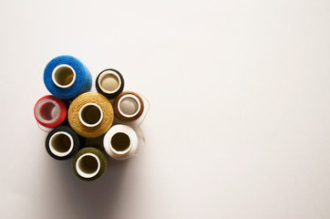 colored skeins of threads stand on a light background