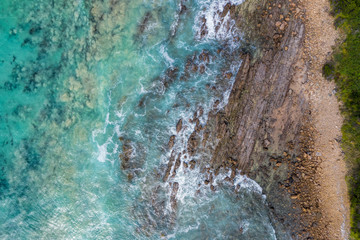 Overhead view of waves breaking against a rocky beach in Victoria Australia
