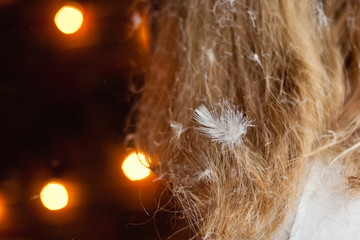 white feather stuck in hair