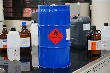 Blue color hazardous dangerous chemical drum barrels with red flammable liquid warning label and ...