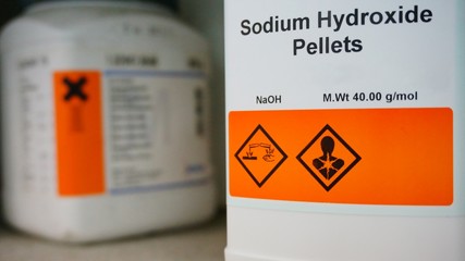 Bottle of Sodium Hydroxide, NaOH with Properties information and its chemical hazard warning...