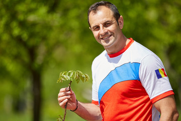 Farmer with a young walnut tree