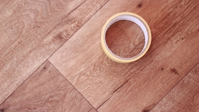 Putting adhesive tape and scissors on the floor