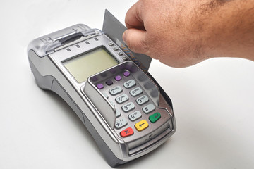 Businessman using payment terminal to pay with credit card.