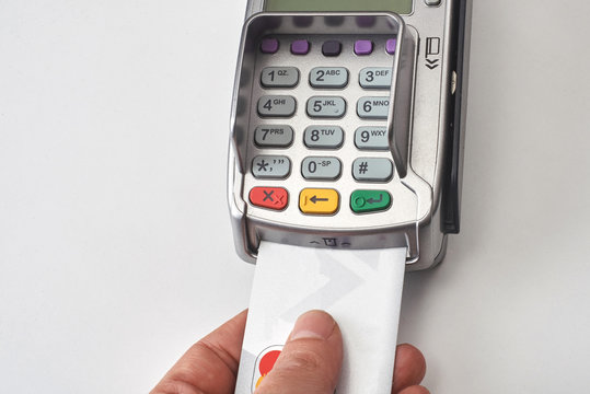 Businessman using payment terminal to pay with credit card.