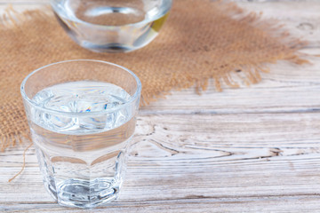 Glasses of water on a wooden table.