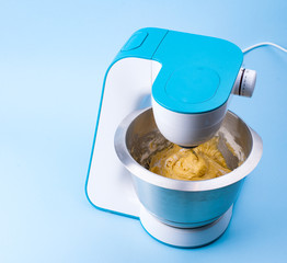 Food processor with dough. Home appliances for the kitchen blue. Free space for text.