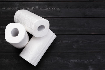 Roll of paper towel on wooden background