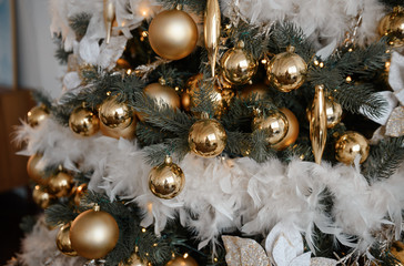 Stylish Christmas living room decor in gold and silver tones. A large beautifully decorated...