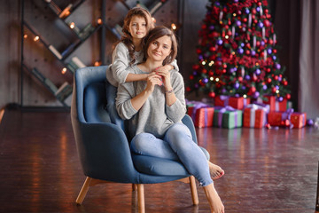 Obraz premium happy family mother and baby little daughter playing in the winter for the Christmas holidays