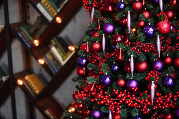 Winter decoration. decoration of the shelf for the new year or Christmas. candles, Christmas tree, books, bows and bumps