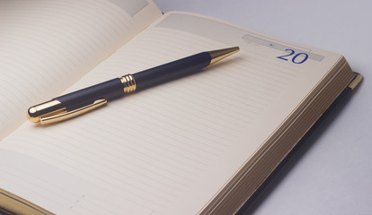 notebook and pen on white background