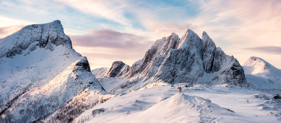 Panorama planinara koji stoji na vrhu snježnog planinskog lanca