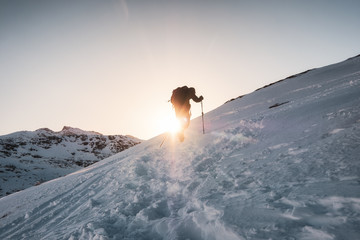 Mountaineer climbing on snowy mountain