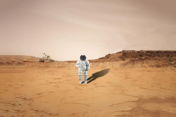 astronaut doing his mission land on planet mars. solar system b. elements of this image furnished...