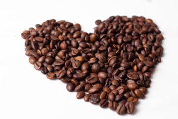 Fototapeta premium heart of coffee beans on white background.