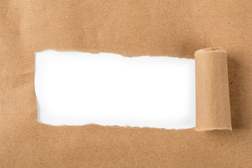 Hole in the paper with torn sides. Yellow paper