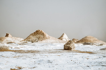 White desert in Egypt, Farafra, wind eroded rock formations at sunset/ - 245105556