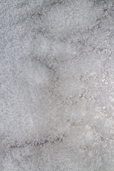 Frozen window photographed in the evening with a flicker of color