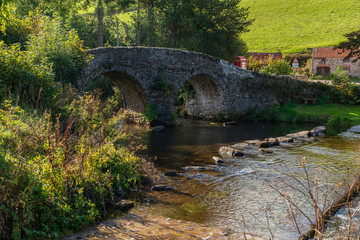 Fototapeta na wymiar Stone bridge over Badgworthy Water in Malmsmead, Devon, England, UK